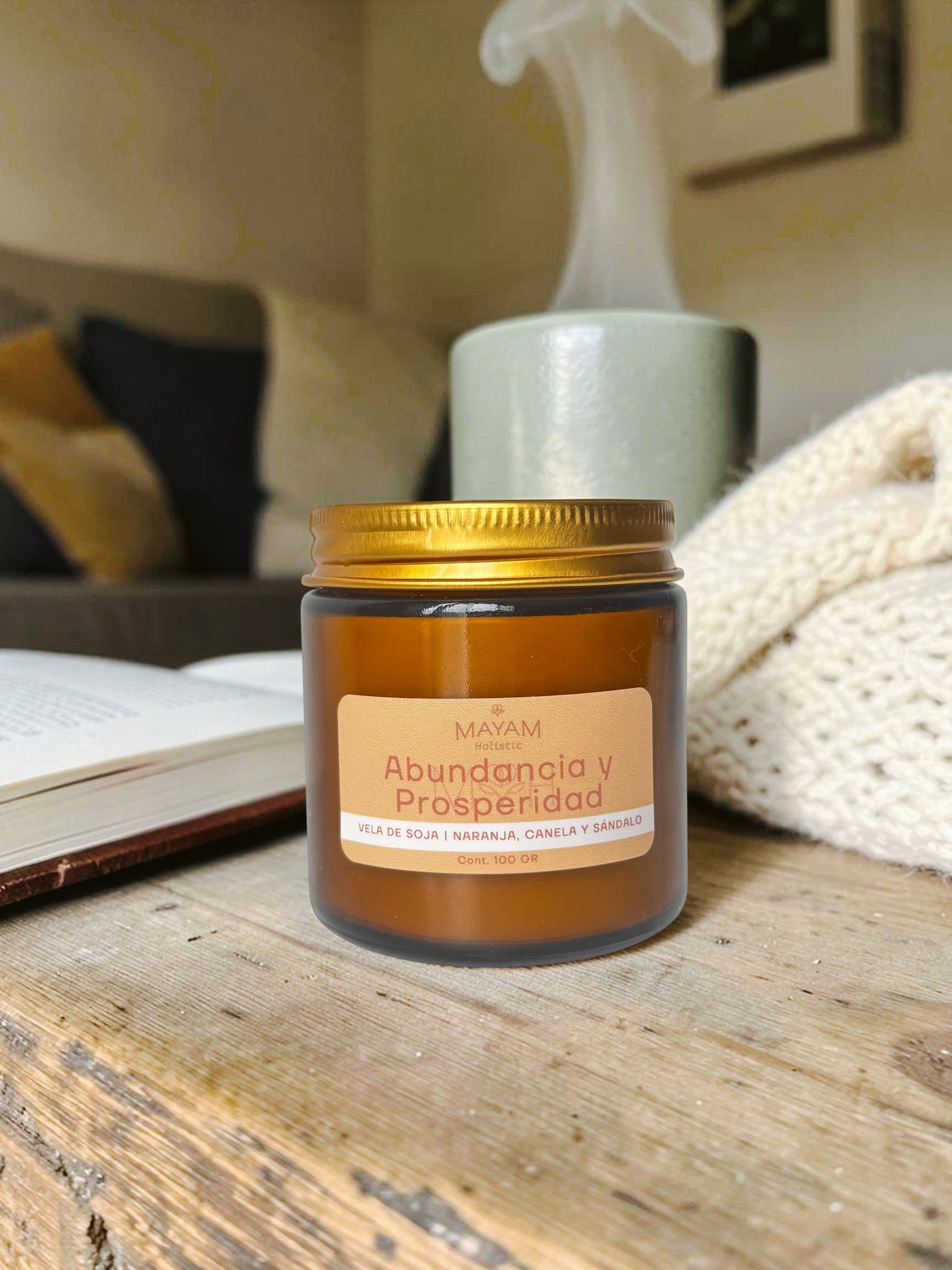 Mayam Holistic soy wax candle with orange, cinnamon, and sandalwood scents for abundance and prosperity. Amber glass jar, 100g.